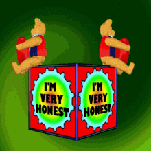 Two bear dolls sitting on a cube with I'm very honest written on it.